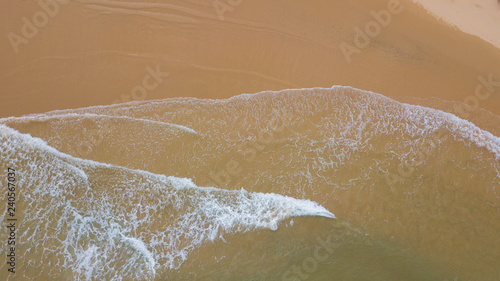 Aerial view beautiful of sea waves, sand from drone. Stock image ocean water, sea surface, sand. Top view on turquoise waves, clear water surface texture. Top view, amazing nature beach background