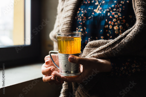 A glass with hot grog in woman's hands photo