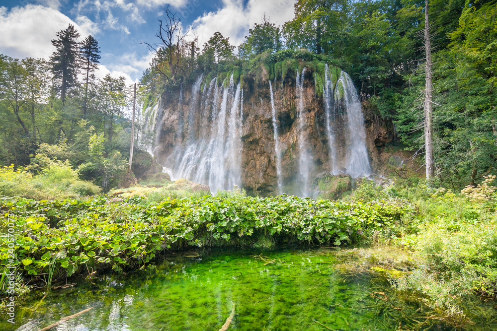 Waterfall at a lake. The Plitvice Lakes National Park, Croatia, Europe.