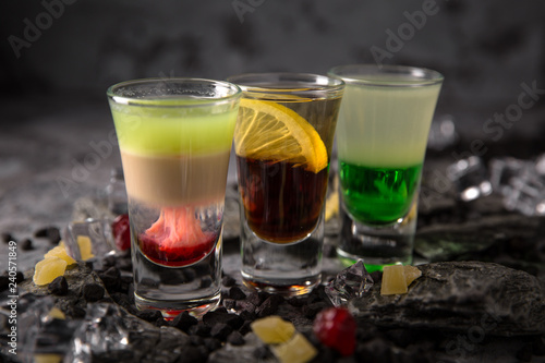 Set of Alcoholic cocktails in shot glasses (shooters). Cool drink from strong vodka, whiskey and sweet liqueurs. Easy Bartenders Recipes and Ideas