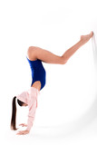 Beautiful young flexible girl dancer standing on hands