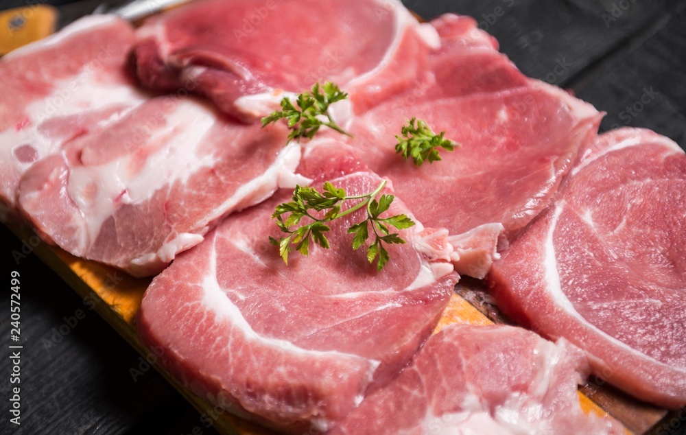 close up scene of pork steak meat with parsley. raw meat steaks close up scene of pork steak meat with parsley. raw meat steaks