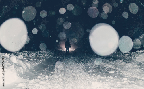 Fototapeta Naklejka Na Ścianę i Meble -  One man on a mysterious snowy night street