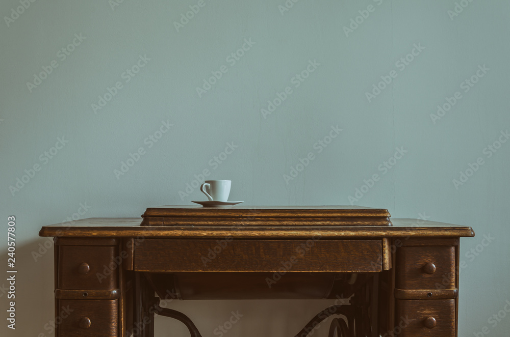 Fototapeta premium SEWING MACHINE - A cup on an old home appliance