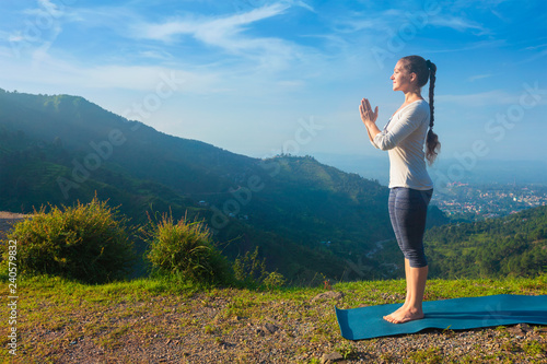 Woman doing yoga in mountains photo
