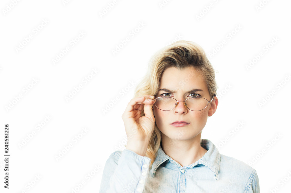 Young beautiful girl teacher in glasses emotionally reeks and looks offended. Conception evil teacher