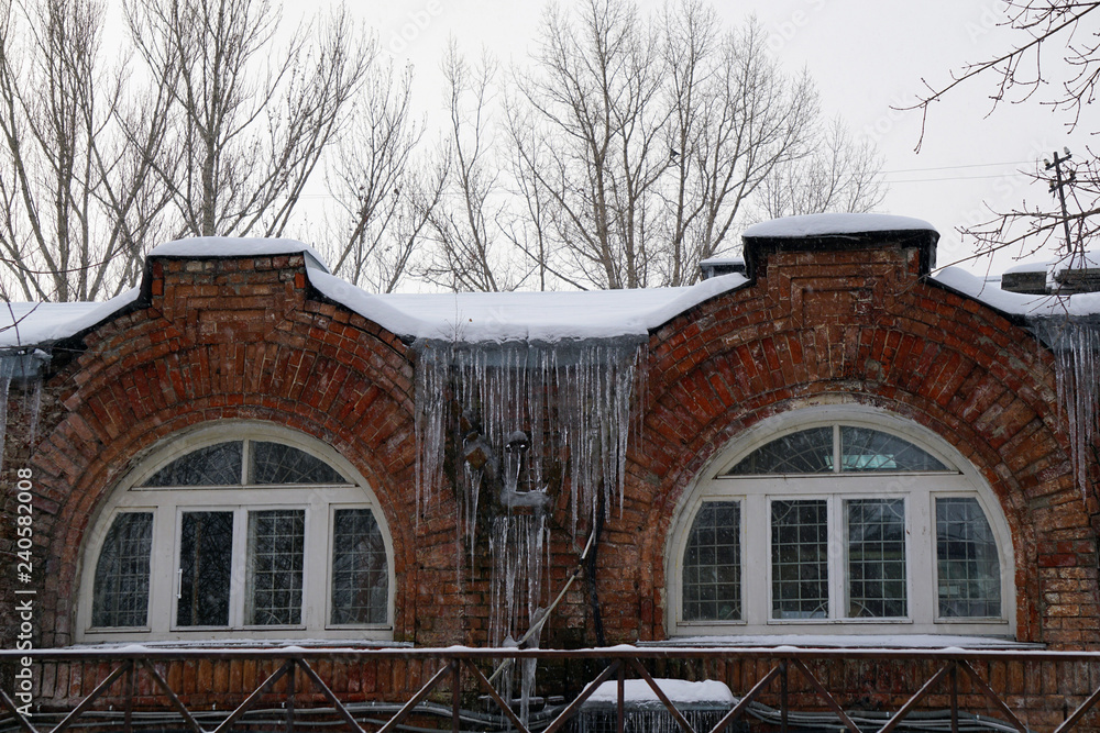 old house with windows arches with icicles