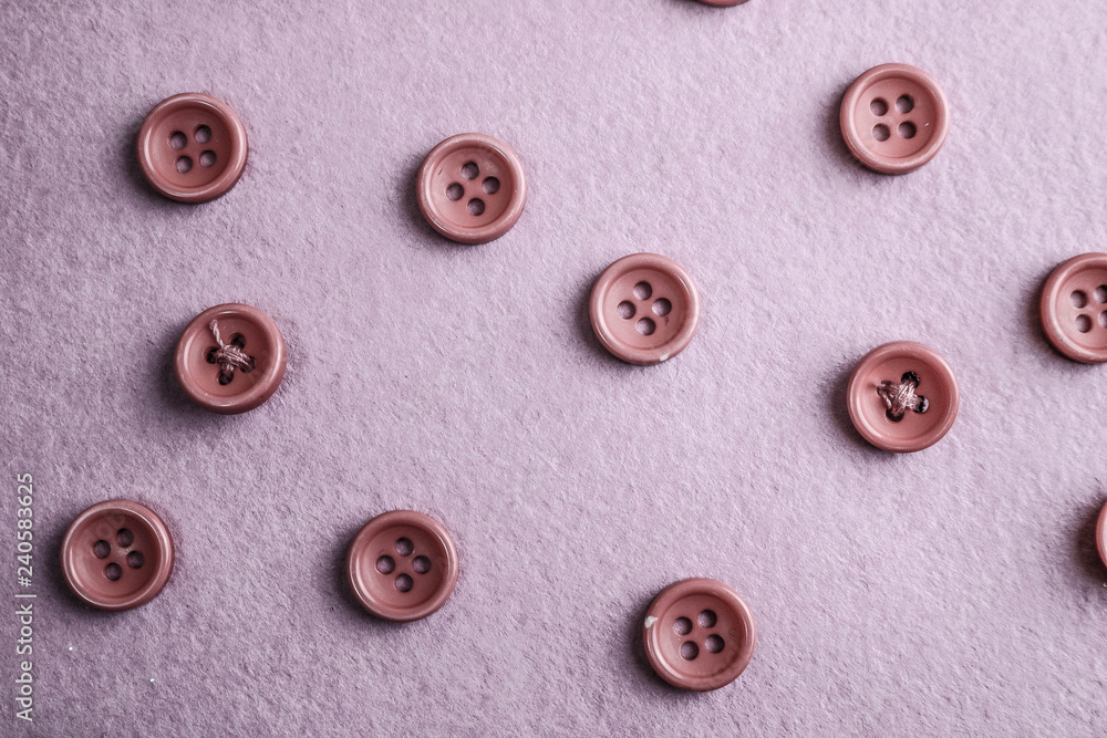 Beautiful texture with many round pink buttons for sewing, needlework. Copy space. Flat lay. Pink, purple background Beautiful texture with many round pink buttons for sewing, needlework. Copy space. Flat lay. Pink, purple background