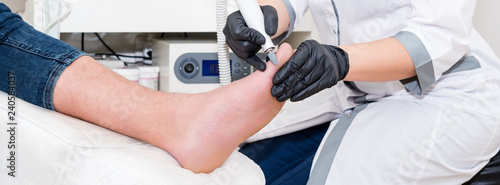 Podology treatment. Podiatrist treats foot. Podiatry doctor or dermatologist treats the patient in modern clinic