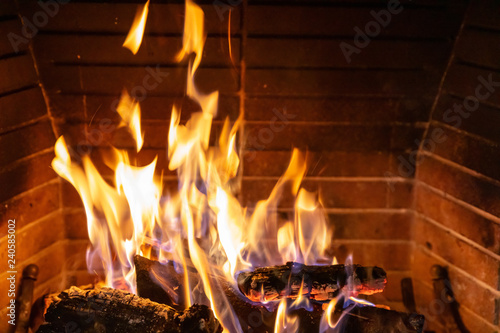 Christmas time. Wood burning in a cozy fireplace at home