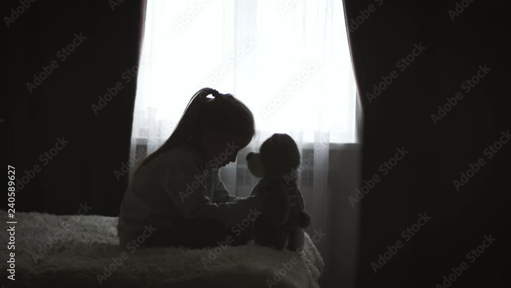 Depressed little girl hugging teddy bear. Depressed little girl hugging teddy bear.