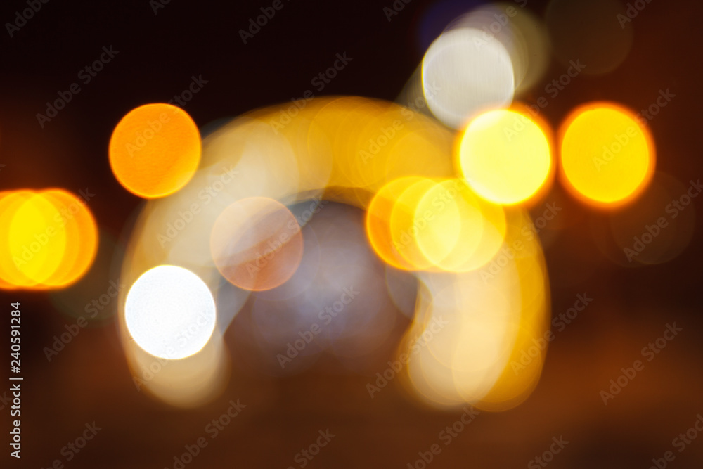 Fototapeta premium Blurred background of colored lights in the form of luminous arches. Image of abstract blurred bokeh background with colored lights. Christmas lights, blur, bokeh, bokeh lights, bokeh background