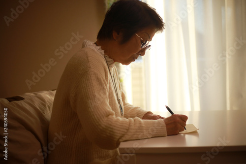 手紙を書くシニア女性