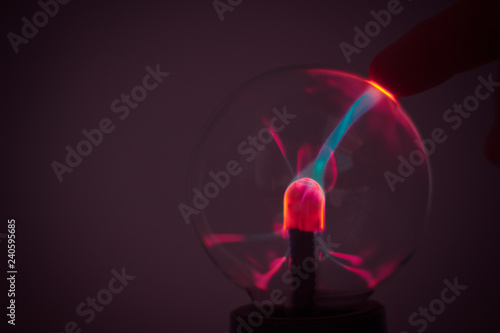 A plasma lamp with pink electricity rays. photo