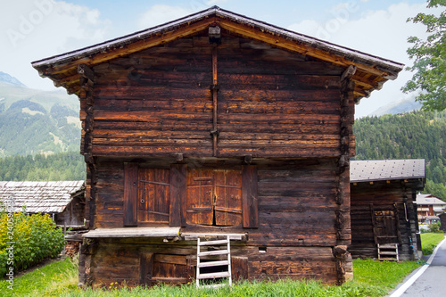 View of a rustic big barn in a village in Switzerland. © CeHa