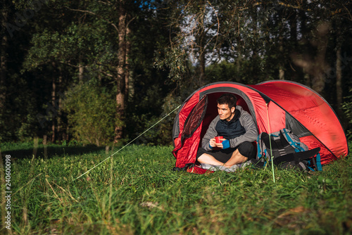 Wallpaper Mural Man camping in Estonia, sitting in tent, drinking coffee Torontodigital.ca