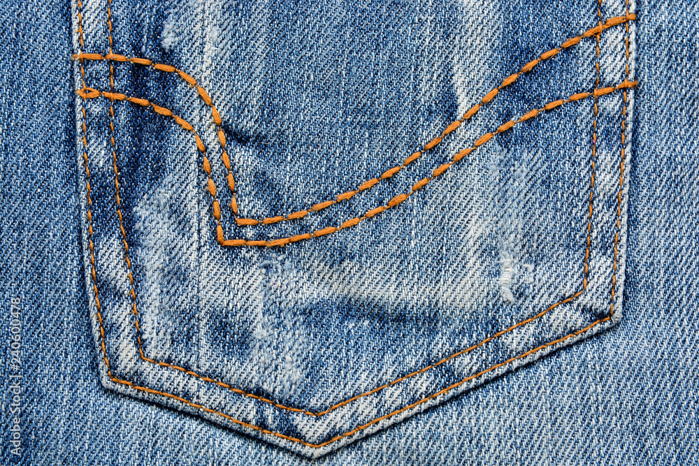 Denim fabric texture with yellow stitching Denim fabric texture with yellow stitching