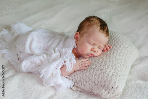 Portrait of cute sleeping newborn baby in light bedroom. Family, motherhood, love, health, innocence and care © AnnKot