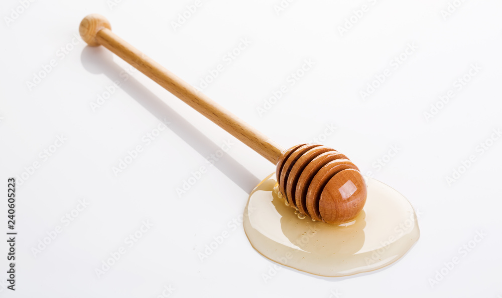 Honey and honey dipper on white background Honey and honey dipper on white background