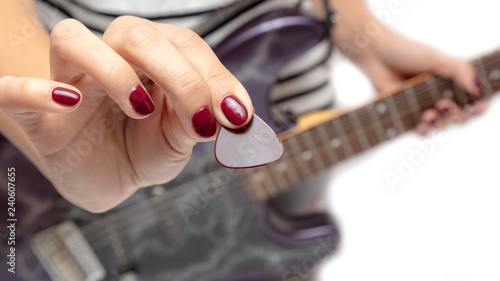 Girl playing an electric guitar on white background © schankz