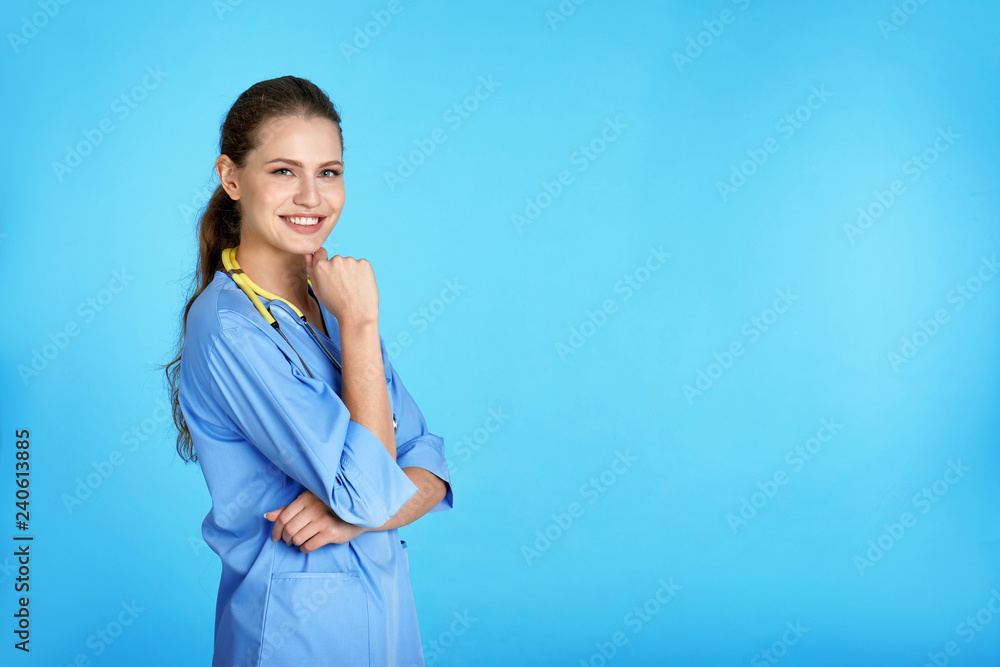 Portrait of young medical assistant with stethoscope on color background. Space for text Portrait of young medical assistant with stethoscope on color background. Space for text