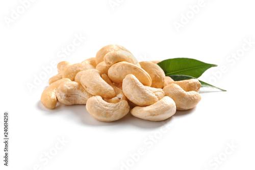 Tasty cashew nuts with leaves isolated on white