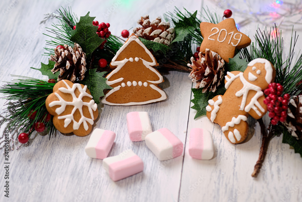 ginger biscuit and marshmallow on white background with Christmas tree