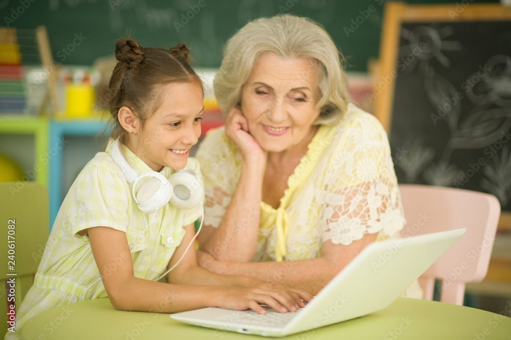 Portrait of grandmother and daughter using modern laptop Portrait of grandmother and daughter using modern laptop