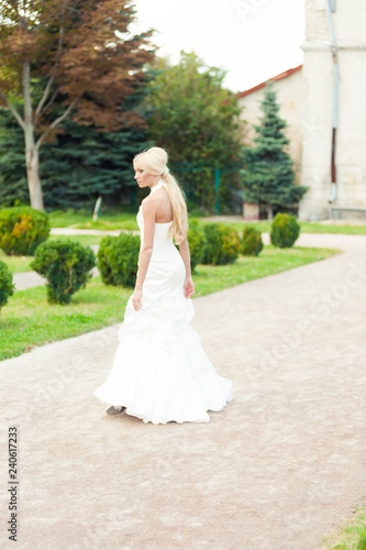 Bride blonde in a luxurious wedding dress