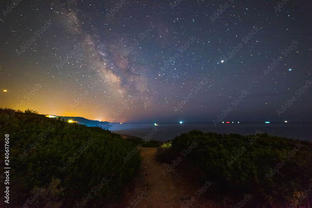 Milky way over Sardinia coastline at night