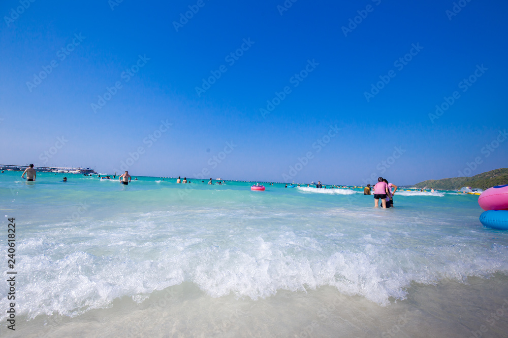 Seascape of Koh Larn island. Small tropical beach in Pattaya area, Thailand with lot of tourist, white sand and blue sea, perfect for traveling.