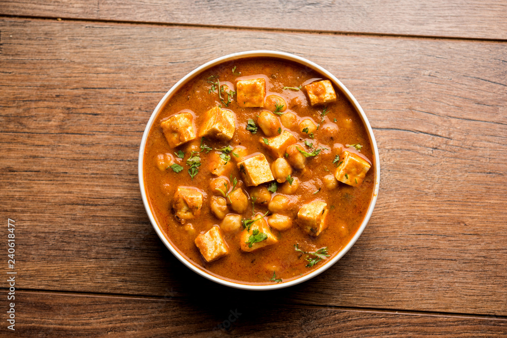 Chole Paneer curry made using boiled chickpea with cottage cheese with spices. Popular North Indian recipe. served in a bowl or serving pan. Selective focus Chole Paneer curry made using boiled chickpea with cottage cheese with spices. Popular North Indian recipe. served in a bowl or serving pan. Selective focus
