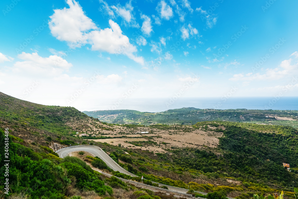 Winding road on a green hill in Sardinia