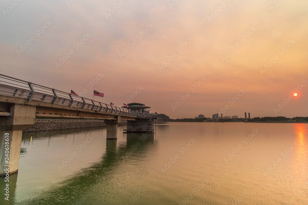 Sunset near the bridge with Malaysian flag waiving.