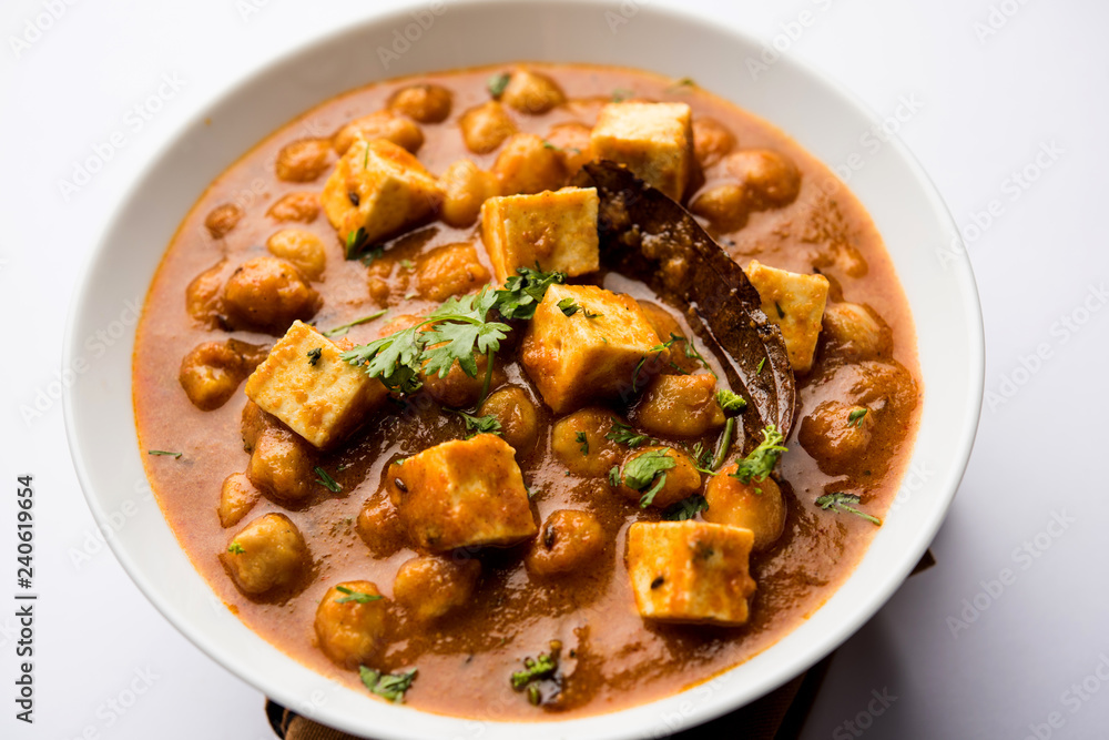 Chole Paneer curry made using boiled chickpea with cottage cheese with spices. Popular North Indian recipe. served in a bowl or serving pan. Selective focus Chole Paneer curry made using boiled chickpea with cottage cheese with spices. Popular North Indian recipe. served in a bowl or serving pan. Selective focus