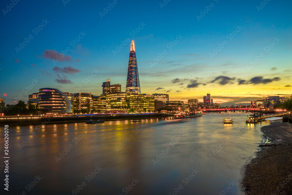 Looking across the River Thames with the London city skyline at sunset 