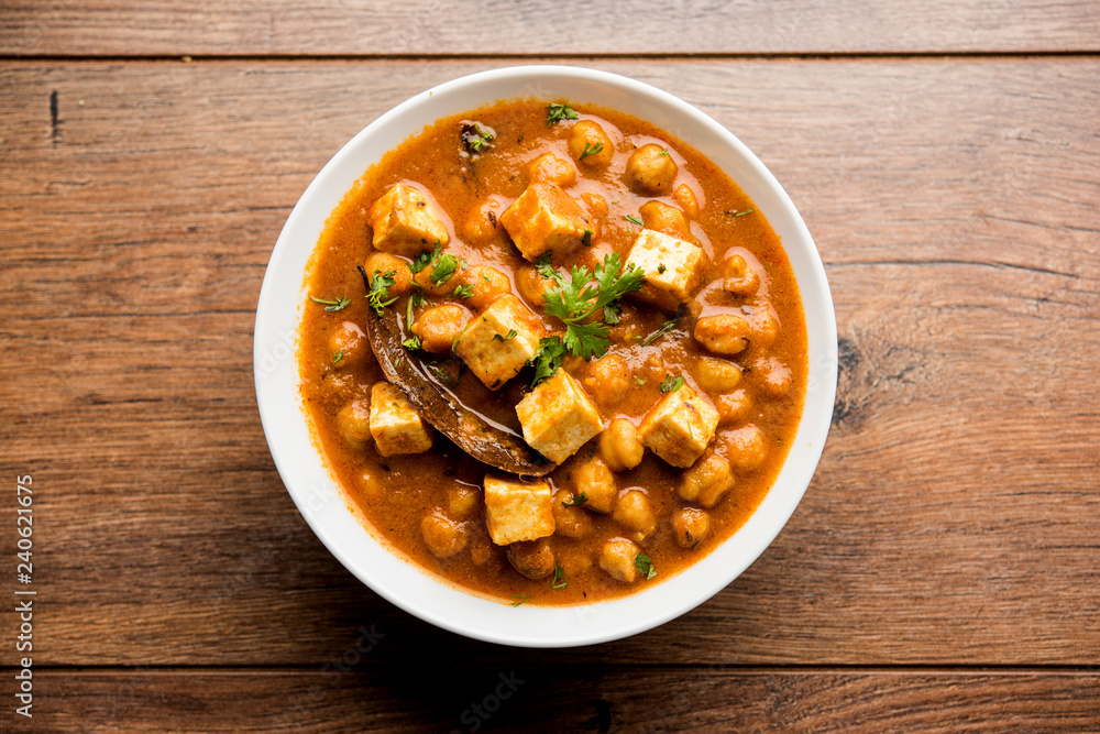 Chole Paneer curry made using boiled chickpea with cottage cheese with spices. Popular North Indian recipe. served in a bowl or serving pan. Selective focus Chole Paneer curry made using boiled chickpea with cottage cheese with spices. Popular North Indian recipe. served in a bowl or serving pan. Selective focus