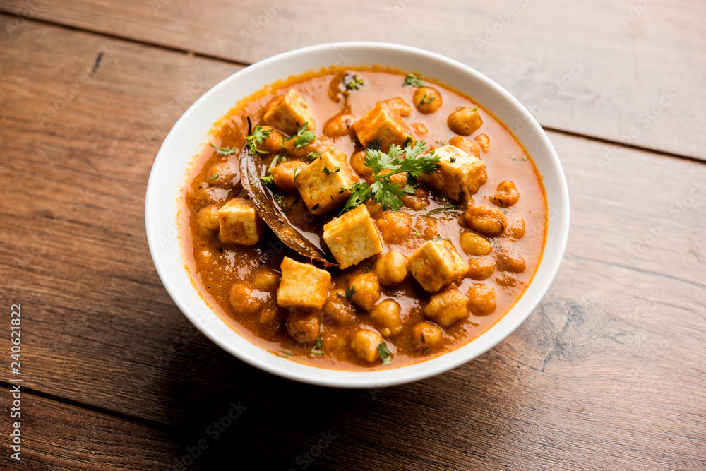 Chole Paneer curry made using boiled chickpea with cottage cheese with spices. Popular North Indian recipe. served in a bowl or serving pan. Selective focus Chole Paneer curry made using boiled chickpea with cottage cheese with spices. Popular North Indian recipe. served in a bowl or serving pan. Selective focus