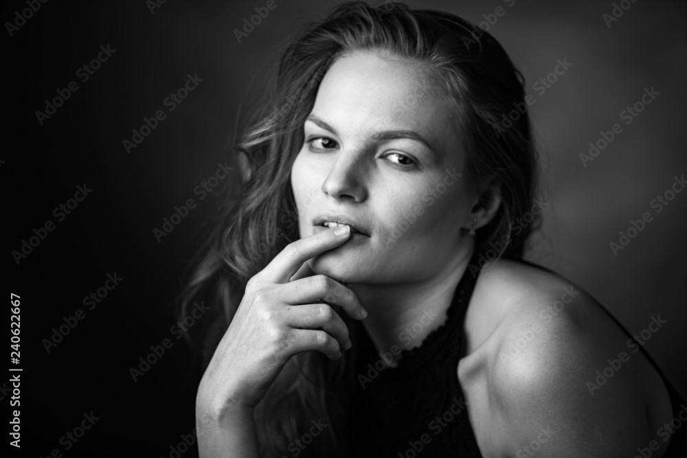 Dramatic black and white portrait of a beautiful girl on a dark background Dramatic black and white portrait of a beautiful girl on a dark background
