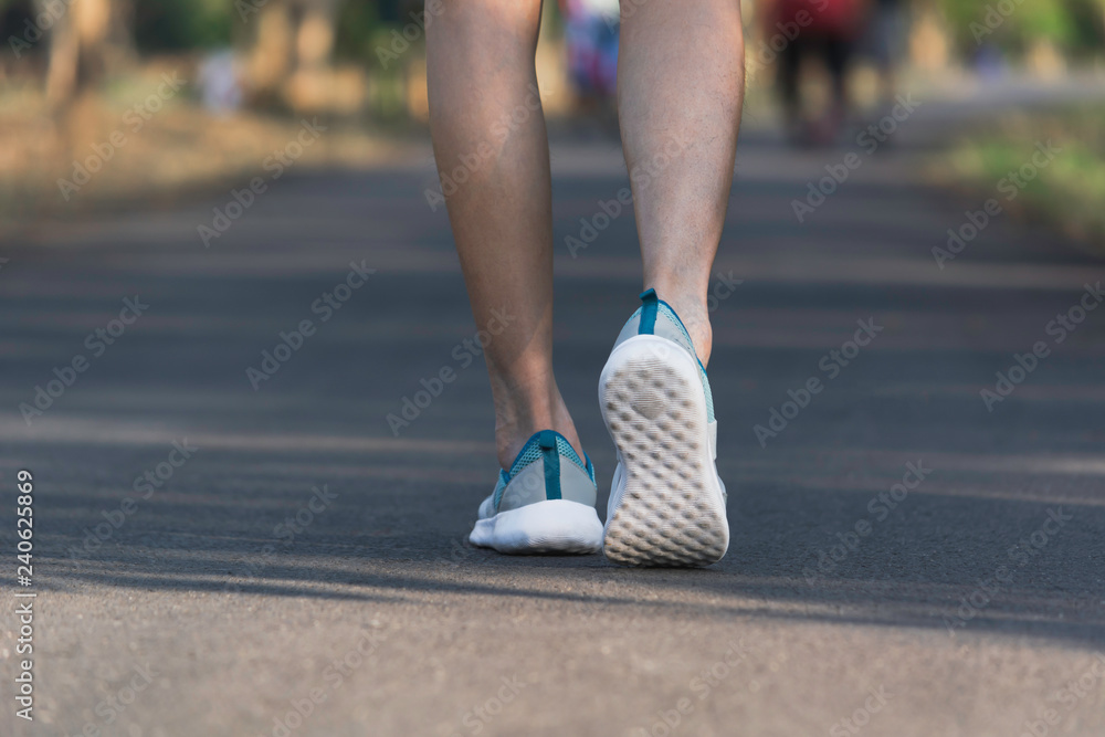 The female walking at the morning for warm up body for jogging and exercise.