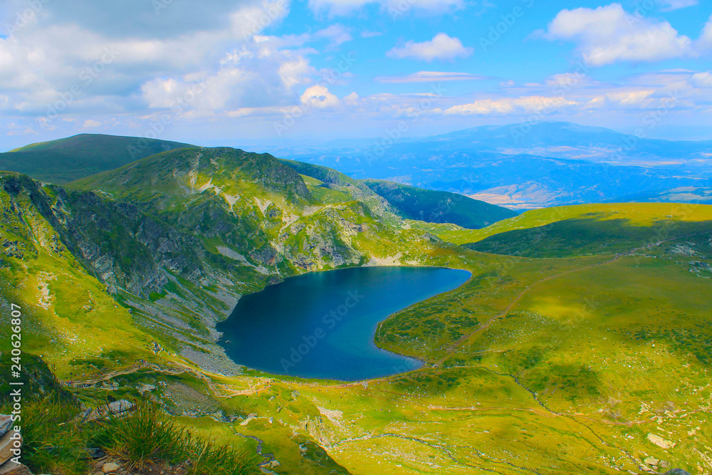 Panoramic picture of a high mountain lake in a sunny day