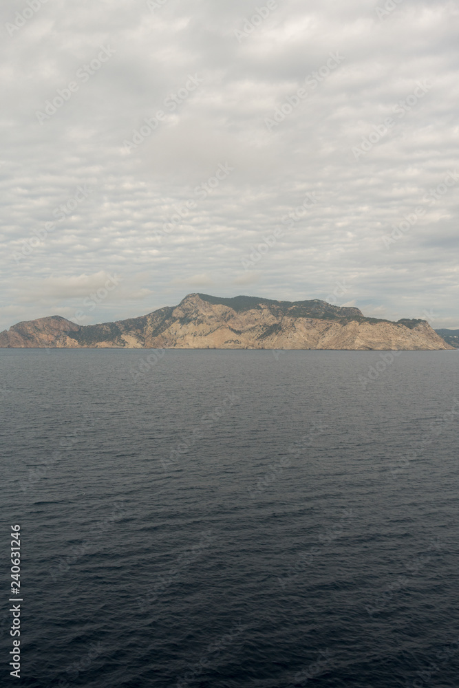 The island of es vedra from behind from a boat