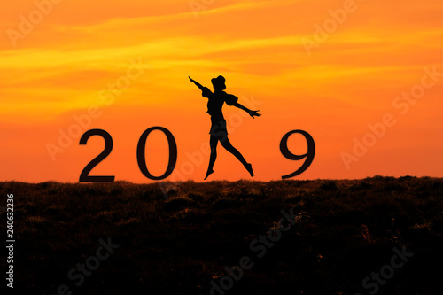 Silhouette of people jump and kick number 8 the rock with New year 2019 concept.