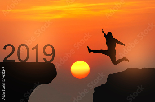 Silhouette of people jump and kick number 8 the rock with New year 2019 concept. © suparat1983