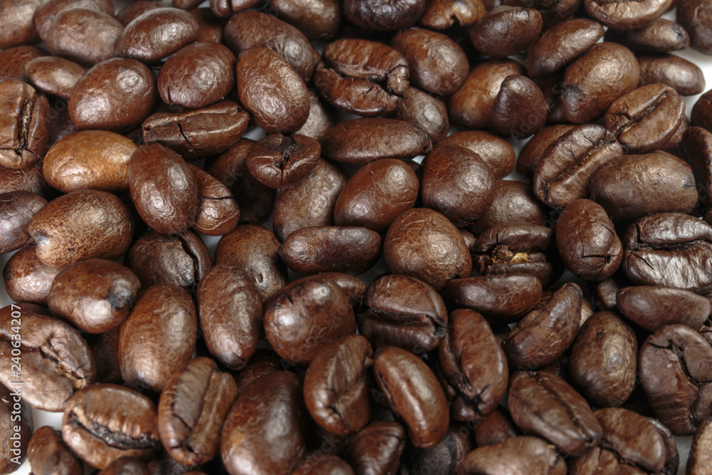 Well-roasted coffee beans background closeup. Well-roasted coffee beans background closeup.