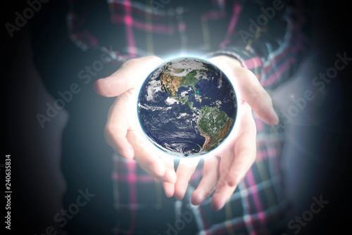 close up person's hands holding lighten planet earth, space concept. Elements of this image furnished by NASA