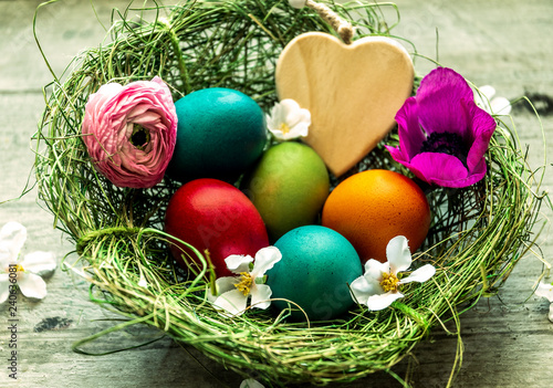 Frohe Ostern, Osternest mit bunten Ostereiern und Herz - Happy Easter,  Easter nest with colorful Easter eggs and heart
