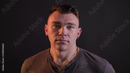 Closeup portrait of handsome caucasian adult man looking at camera and waving with his head in token of disagreement photo