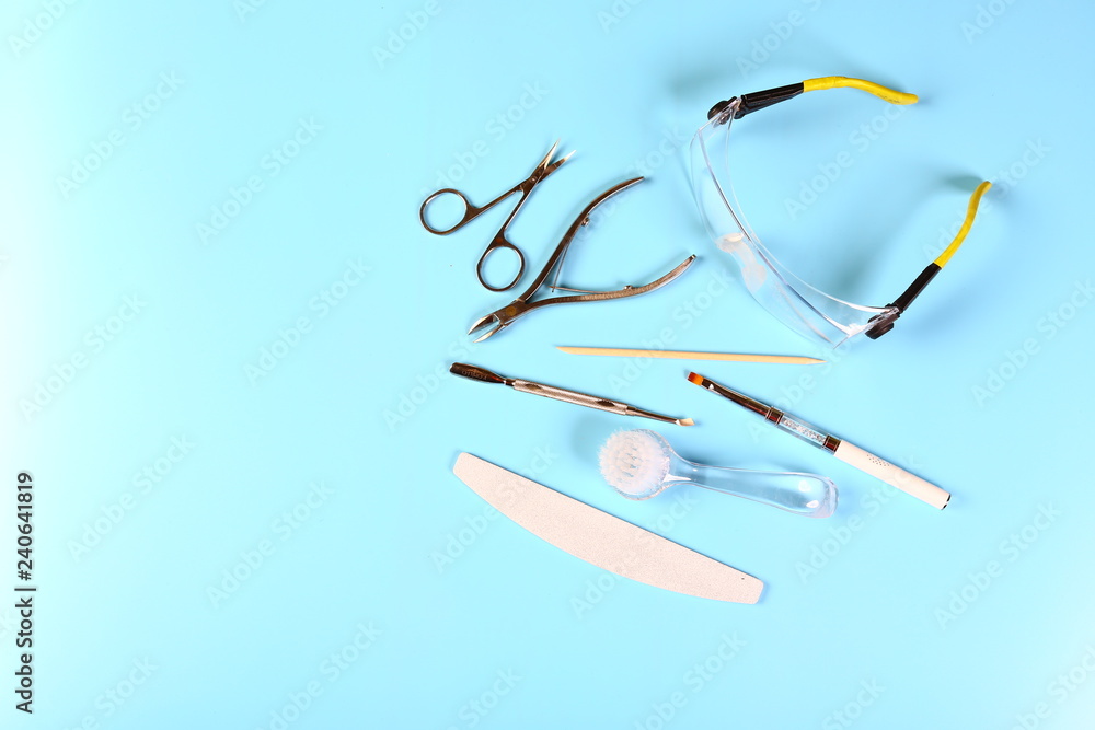 set of manicure accessories on blue background top view. flat lay composition with copy space. the concept of personal protective equipment