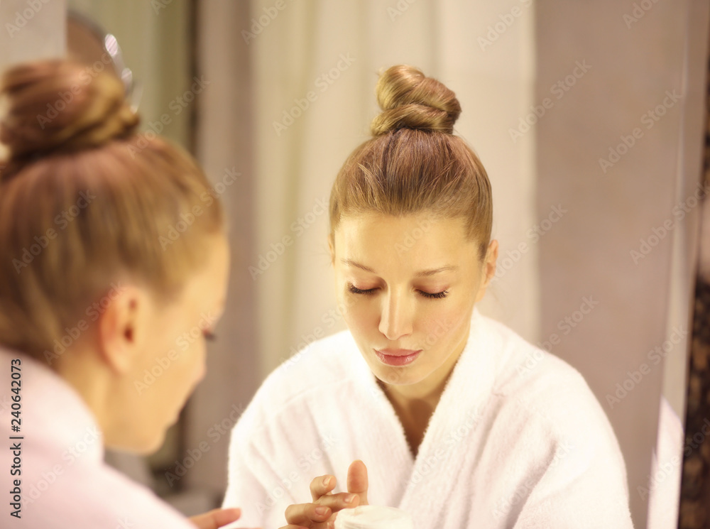 Magic anti-aging cream.Applying the cream
